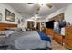 Spacious main bedroom with hardwood flooring, a ceiling fan and TV at 905 Flewelling Ave, Ocoee, FL 34761