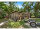 Exterior of backyard shed with tools and work area at 905 Flewelling Ave, Ocoee, FL 34761