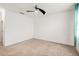 A well-lit bedroom with neutral carpet and a ceiling fan for added comfort at 9188 Chandler Dr, Groveland, FL 34736