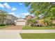 Inviting single-Gathering home with a brick driveway, two-car garage, and lush green lawn at 9188 Chandler Dr, Groveland, FL 34736