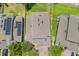 An aerial view displaying the roof of the home, solar panels, and surrounding landscaping at 922 Grazie Loop, Davenport, FL 33837
