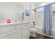 Bright bathroom featuring modern fixtures, white subway tile, and a tub with a shower at 922 Grazie Loop, Davenport, FL 33837