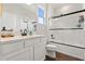 Bright bathroom featuring a white vanity with a modern sink and a tiled shower with a glass door at 922 Grazie Loop, Davenport, FL 33837
