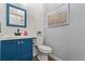 Small bathroom featuring wainscoting, an art print, and a blue vanity with a white sink at 922 Grazie Loop, Davenport, FL 33837