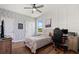 Cozy bedroom with a ceiling fan, patterned wallpaper, and lots of natural light at 922 Grazie Loop, Davenport, FL 33837