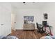 Well-lit bedroom featuring light wood floors, a ceiling fan, and an open entry way at 922 Grazie Loop, Davenport, FL 33837