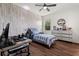 Stylish bedroom with a wood-accent wall, modern furniture, and bright natural light at 922 Grazie Loop, Davenport, FL 33837