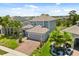 Charming two-story home showcasing its architectural details, manicured lawn, and mature palm tree landscaping at 922 Grazie Loop, Davenport, FL 33837