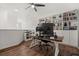 Bright home office with built-in bookshelves, wood floors, and modern desk setup at 922 Grazie Loop, Davenport, FL 33837