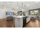 Bright and open kitchen with a large island, bar seating, and views of the living room and dining area at 922 Grazie Loop, Davenport, FL 33837