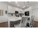 Modern kitchen with white cabinets, a large island, a stainless steel refrigerator, and an undermount sink at 922 Grazie Loop, Davenport, FL 33837