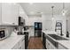 Contemporary kitchen with white cabinets, stainless steel appliances, undermount sink, and wood-look flooring at 922 Grazie Loop, Davenport, FL 33837