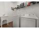 Modern laundry room features a utility sink, Samsung washer and dryer and wire shelving at 922 Grazie Loop, Davenport, FL 33837