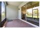 An outdoor patio featuring brick flooring, screened walls, and sliding glass doors that lead to the home's interior at 922 Grazie Loop, Davenport, FL 33837