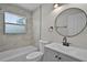 Updated bathroom showcasing a new vanity, toilet, tub, and stylish mirror at 1011 W 13Th St, Lakeland, FL 33805