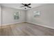 Bright bedroom featuring wood flooring, two windows for natural light, and a ceiling fan at 1011 W 13Th St, Lakeland, FL 33805