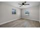 Comfortable bedroom featuring light-colored walls, wood flooring, and a ceiling fan at 1011 W 13Th St, Lakeland, FL 33805