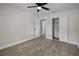 Spacious bedroom features neutral walls, wood flooring, closet storage and a ceiling fan at 1011 W 13Th St, Lakeland, FL 33805