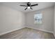 Well-lit bedroom featuring wood flooring, a ceiling fan, and large window at 1011 W 13Th St, Lakeland, FL 33805