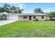 Charming single-story home features a well-maintained lawn, brick facade, and attached garage at 1011 W 13Th St, Lakeland, FL 33805
