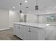 Stylish kitchen island with white cabinets, quartz counters, and pendant lighting overhead at 1011 W 13Th St, Lakeland, FL 33805