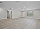 Open living room with luxury vinyl plank flooring, fresh paint, and natural light from the window at 1011 W 13Th St, Lakeland, FL 33805