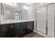 Contemporary bathroom boasts a double vanity, large mirror, and a sleek glass shower at 1159 Mountain Flower Ln, Davenport, FL 33837