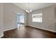Bright dining room features hardwood floors, a chandelier, and sliding glass doors to outdoor patio at 1159 Mountain Flower Ln, Davenport, FL 33837