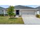 Charming single-story home featuring a well-maintained lawn and a two-car garage at 1159 Mountain Flower Ln, Davenport, FL 33837