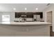 Modern kitchen with stainless steel appliances, marble countertops, and a large island at 1159 Mountain Flower Ln, Davenport, FL 33837