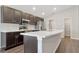 Modern kitchen with stainless steel appliances, dark cabinets, and island at 1159 Mountain Flower Ln, Davenport, FL 33837
