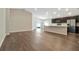 Open-concept living room with hardwood floors and modern recessed lighting at 1159 Mountain Flower Ln, Davenport, FL 33837