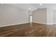 Spacious living room featuring hardwood floors, arched doorways, and neutral paint at 1159 Mountain Flower Ln, Davenport, FL 33837