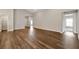 Bright living room featuring hardwood floors and open doorways at 1159 Mountain Flower Ln, Davenport, FL 33837
