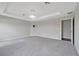 Serene main bedroom offers a tray ceiling and modern lighting at 1159 Mountain Flower Ln, Davenport, FL 33837