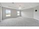 Spacious main bedroom boasts large windows and soft carpeting at 1159 Mountain Flower Ln, Davenport, FL 33837