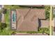 Aerial view of a tile roof, screened-in pool, patio furniture, and meticulously maintained yard at 13232 Alderley Dr, Orlando, FL 32832