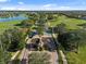 Aerial view of a gated entrance, surrounded by palm trees, leading into a pristine golf course community at 13232 Alderley Dr, Orlando, FL 32832