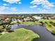 Aerial view showcasing the golf course, surrounding homes and lush landscaping, highlighting the community's amenities at 13232 Alderley Dr, Orlando, FL 32832