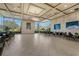Spacious ballroom featuring high ceilings, decorative lighting, tiled floors, and large windows at 13232 Alderley Dr, Orlando, FL 32832