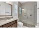 Modern bathroom featuring a glass-enclosed shower and granite vanity at 13232 Alderley Dr, Orlando, FL 32832