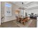 Dining room showcasing stylish chandelier, textured walls, and view to kitchen at 13232 Alderley Dr, Orlando, FL 32832