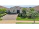 Charming home showcasing a paved driveway, manicured landscaping, and a welcoming front entrance at 13232 Alderley Dr, Orlando, FL 32832