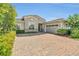 Charming single-Gathering home showcases lush landscaping and a brick paver driveway at 13232 Alderley Dr, Orlando, FL 32832