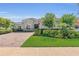 Charming single-story home with well-manicured lawn, brick driveway, and blooming bushes at 13232 Alderley Dr, Orlando, FL 32832