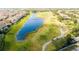 Aerial view of the golf course with a lake alongside and homes lining the edge at 13232 Alderley Dr, Orlando, FL 32832