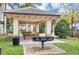 Community grilling area with picnic tables and grill, perfect for outdoor entertaining in a lush, landscaped setting at 13232 Alderley Dr, Orlando, FL 32832