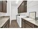 Functional laundry room with ample counter space, cabinetry, and modern appliances for efficient chores at 13232 Alderley Dr, Orlando, FL 32832