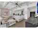 Open-concept living room with coffered ceilings, ample seating and natural light at 13232 Alderley Dr, Orlando, FL 32832