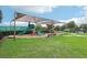 Large community playground with slides, climbing structures, and ample shade for a comfortable play experience at 13232 Alderley Dr, Orlando, FL 32832